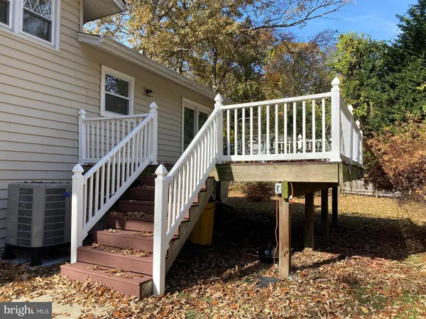 a view of a house with backyard and deck