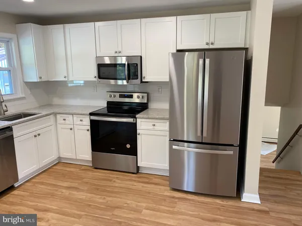 a kitchen with a refrigerator sink and microwave