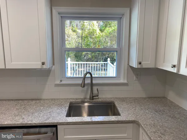 a kitchen with a sink and wooden cabinets