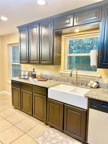a bathroom with a granite countertop sink and a vanity