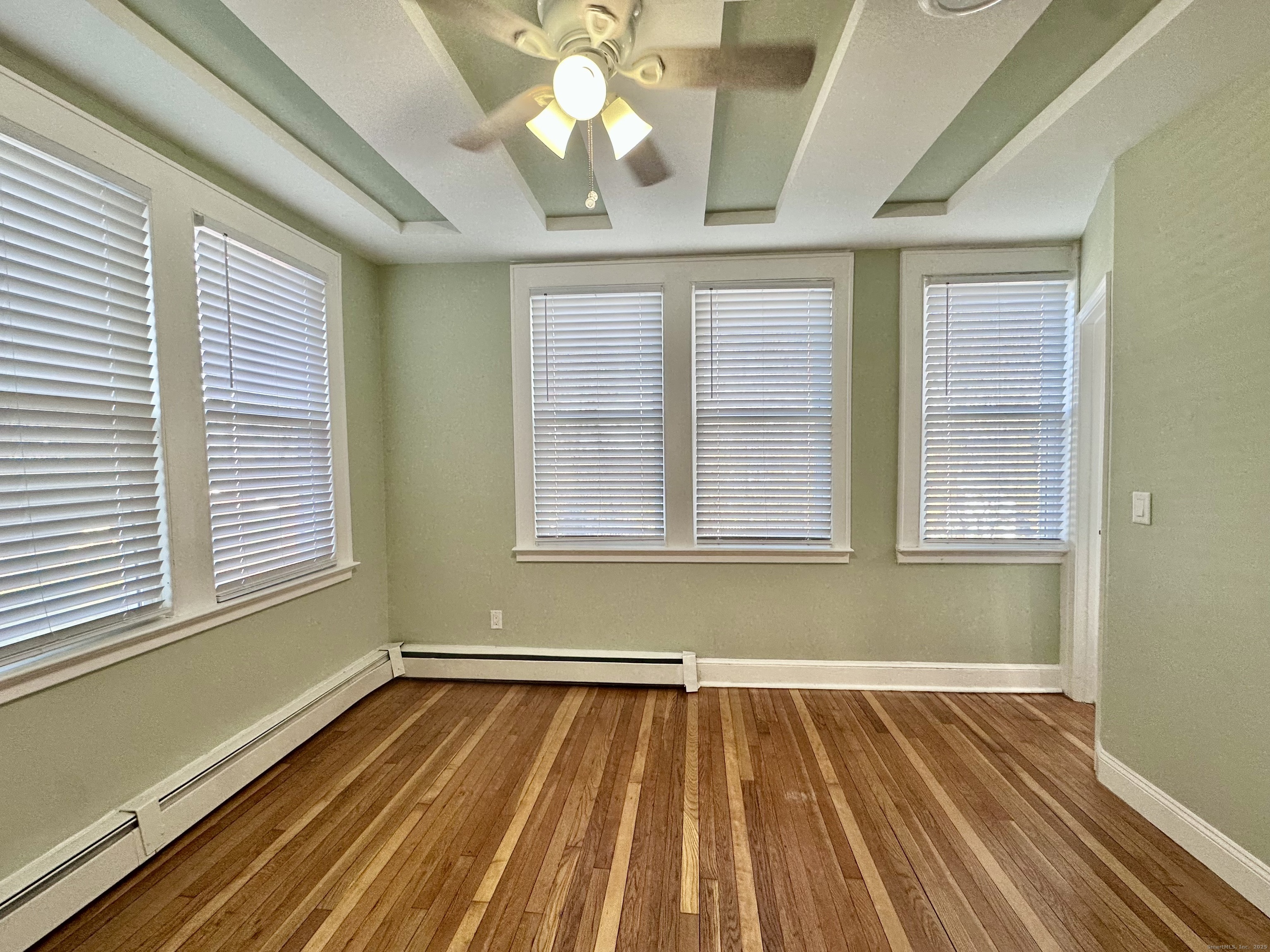 928 Townsend Avenue, Unit 1 New Haven, CT 06512 - Photo 11 of 19 a view of a room with wooden floor and windows
