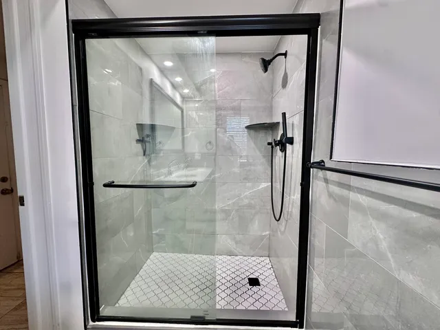 a bathroom with a glass shower door