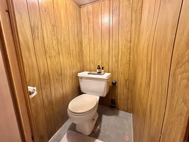 a bathroom with a toilet a sink and a shower curtain