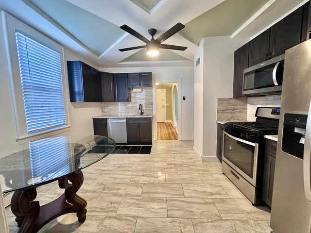 a kitchen with a sink stainless steel appliances and cabinets