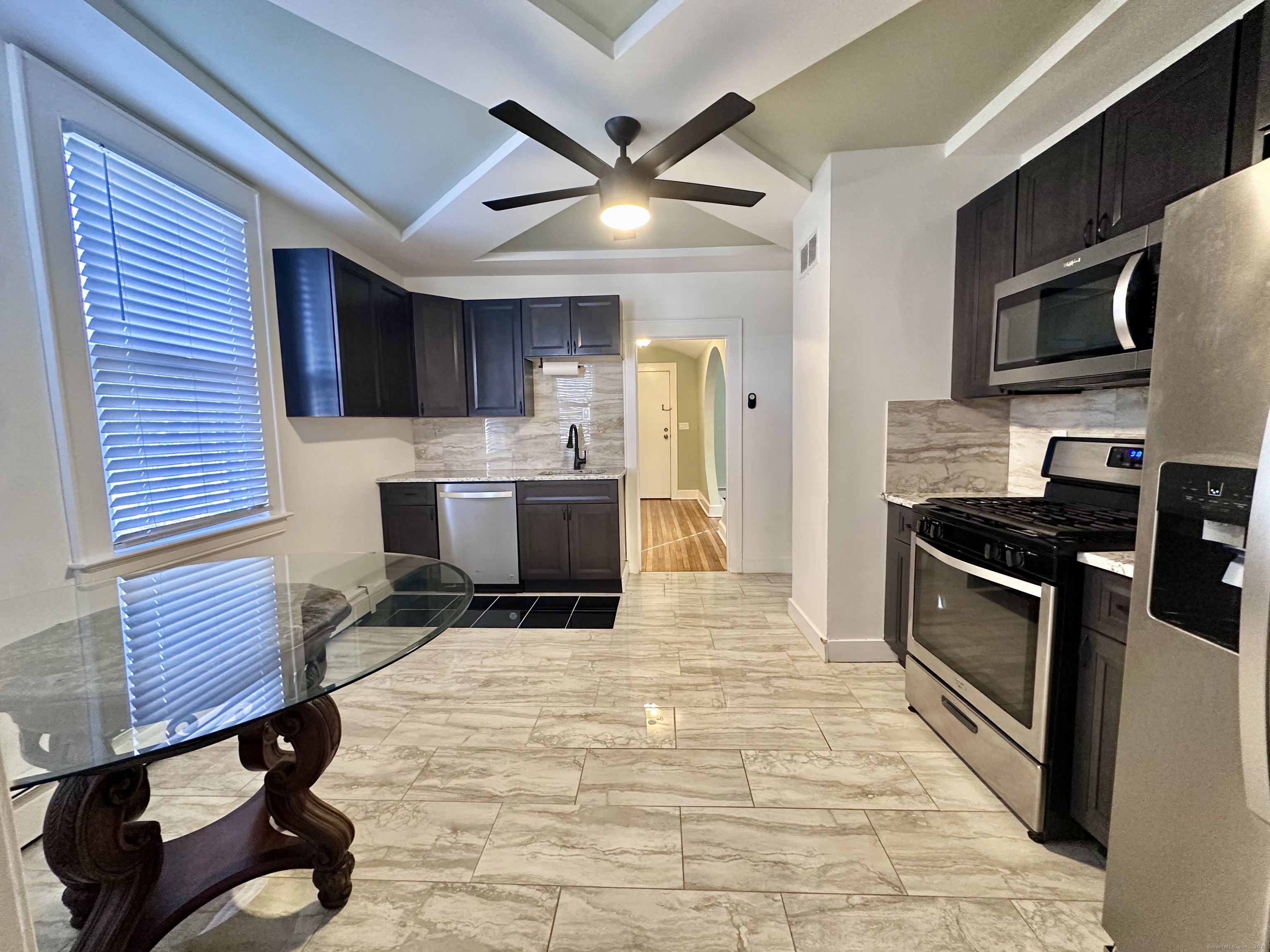 928 Townsend Avenue, Unit 1 New Haven, CT 06512 - Photo 3 of 19 a kitchen with a sink stainless steel appliances and cabinets