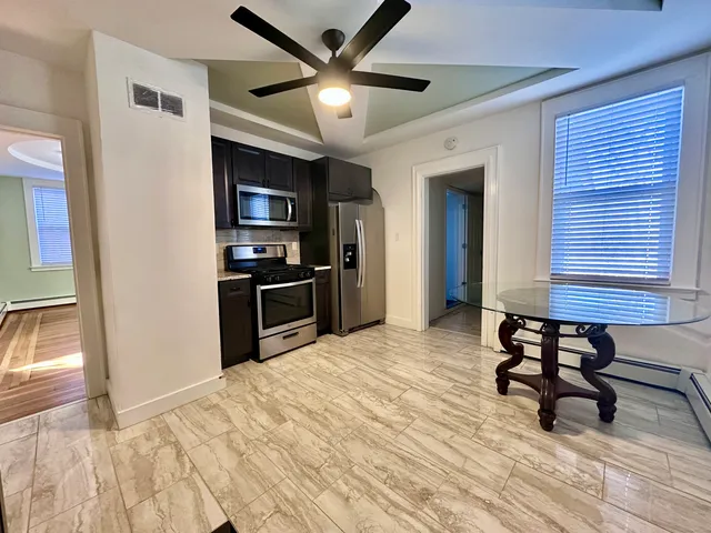 a view of a workspace with furniture and wooden floor