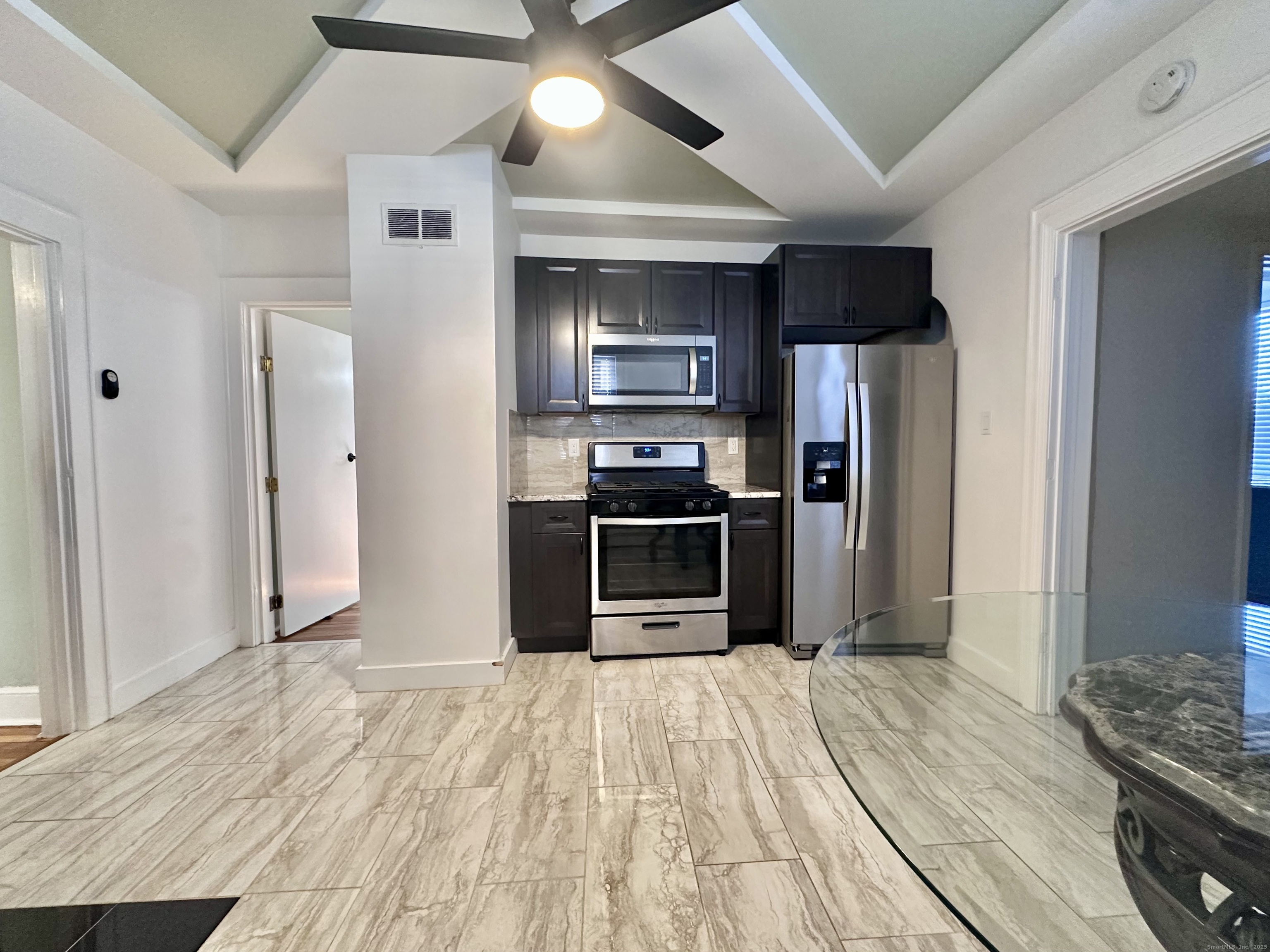 928 Townsend Avenue, Unit 1 New Haven, CT 06512 - Photo 5 of 19 a kitchen with stainless steel appliances kitchen island granite countertop a refrigerator and a sink