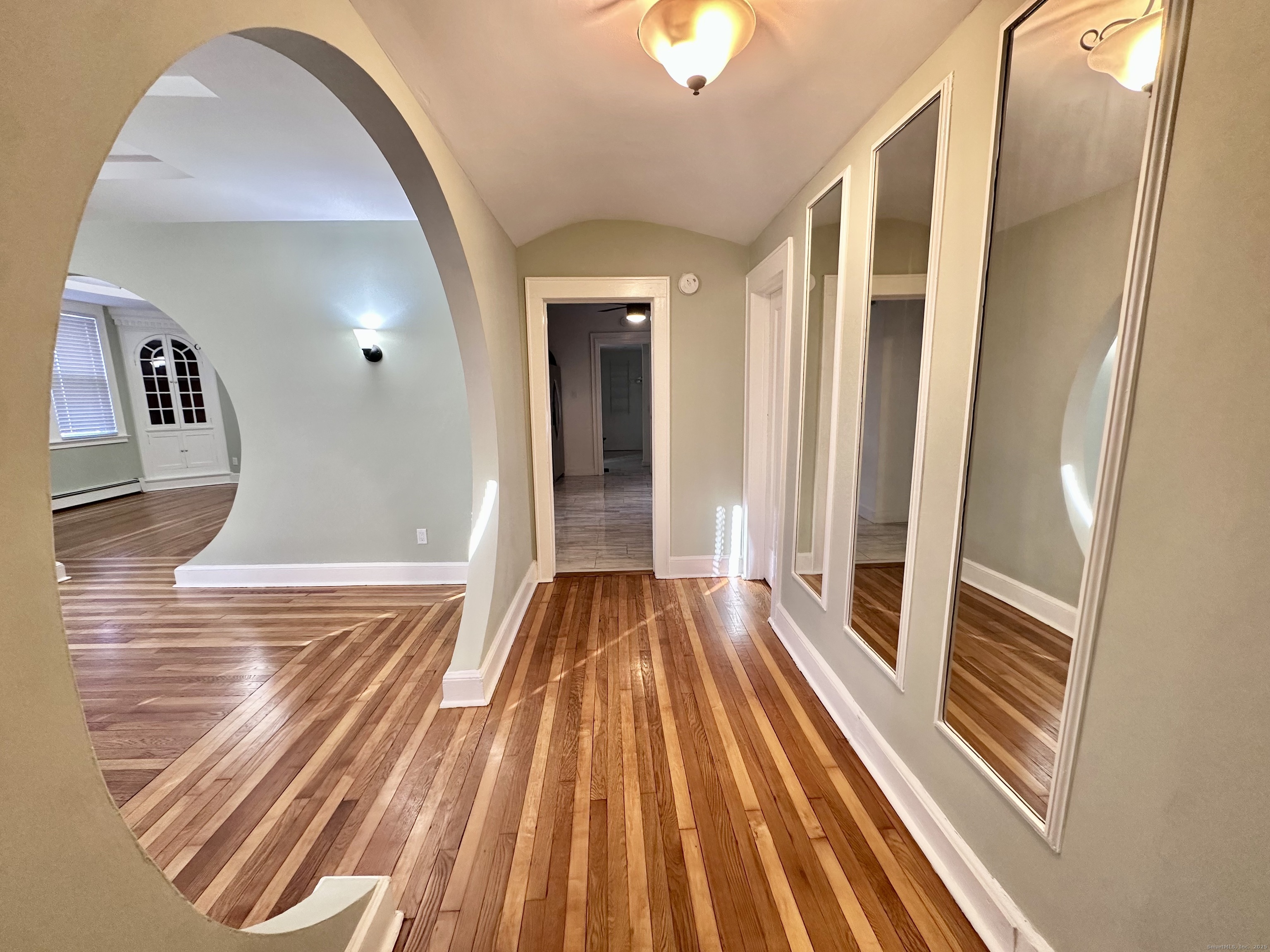 928 Townsend Avenue, Unit 1 New Haven, CT 06512 - Photo 7 of 19 a view of a hallway view with wooden floor and staircase