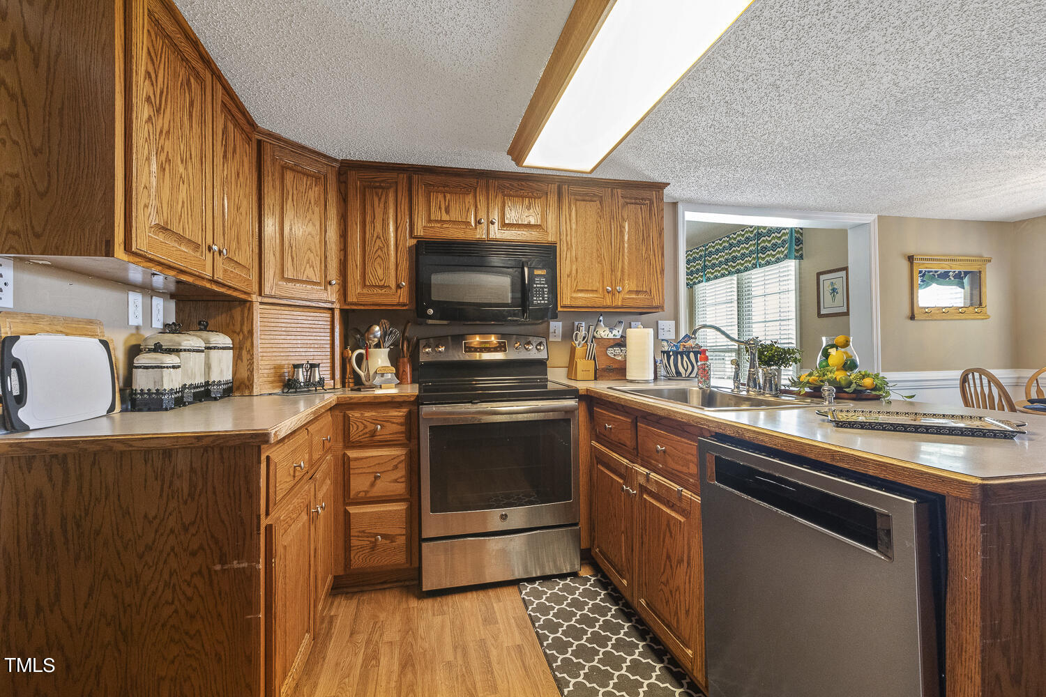 195 Williams Road Coats, NC 27521 - Photo 35 of 100 a kitchen with stainless steel appliances granite countertop a sink stove and refrigerator