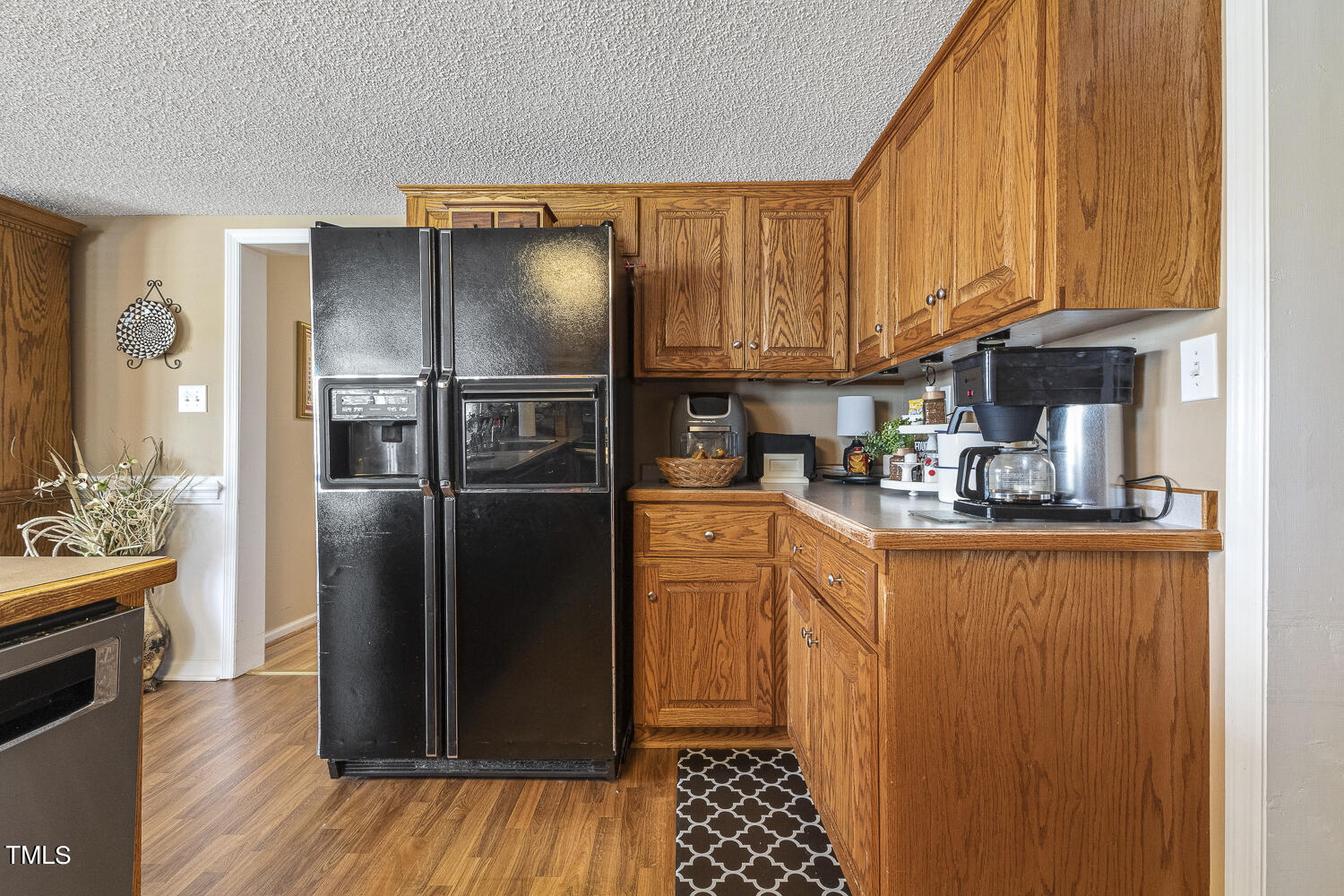 195 Williams Road Coats, NC 27521 - Photo 37 of 100 a kitchen with stainless steel appliances granite countertop a refrigerator a stove and a sink with wooden floor