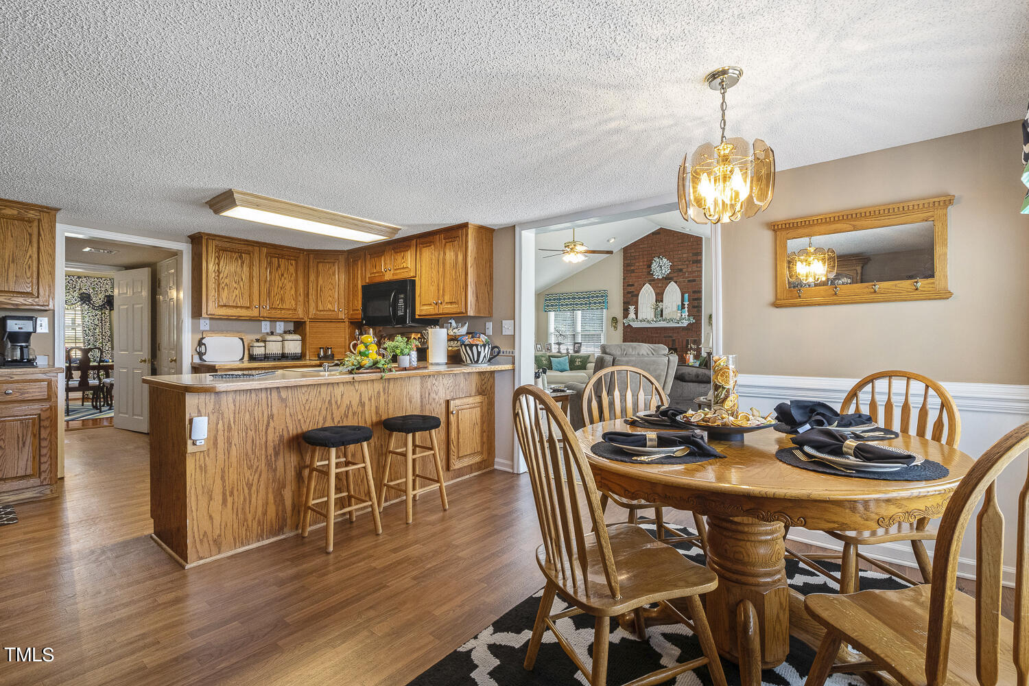 195 Williams Road Coats, NC 27521 - Photo 39 of 100 a dining room with furniture a chandelier and wooden floor