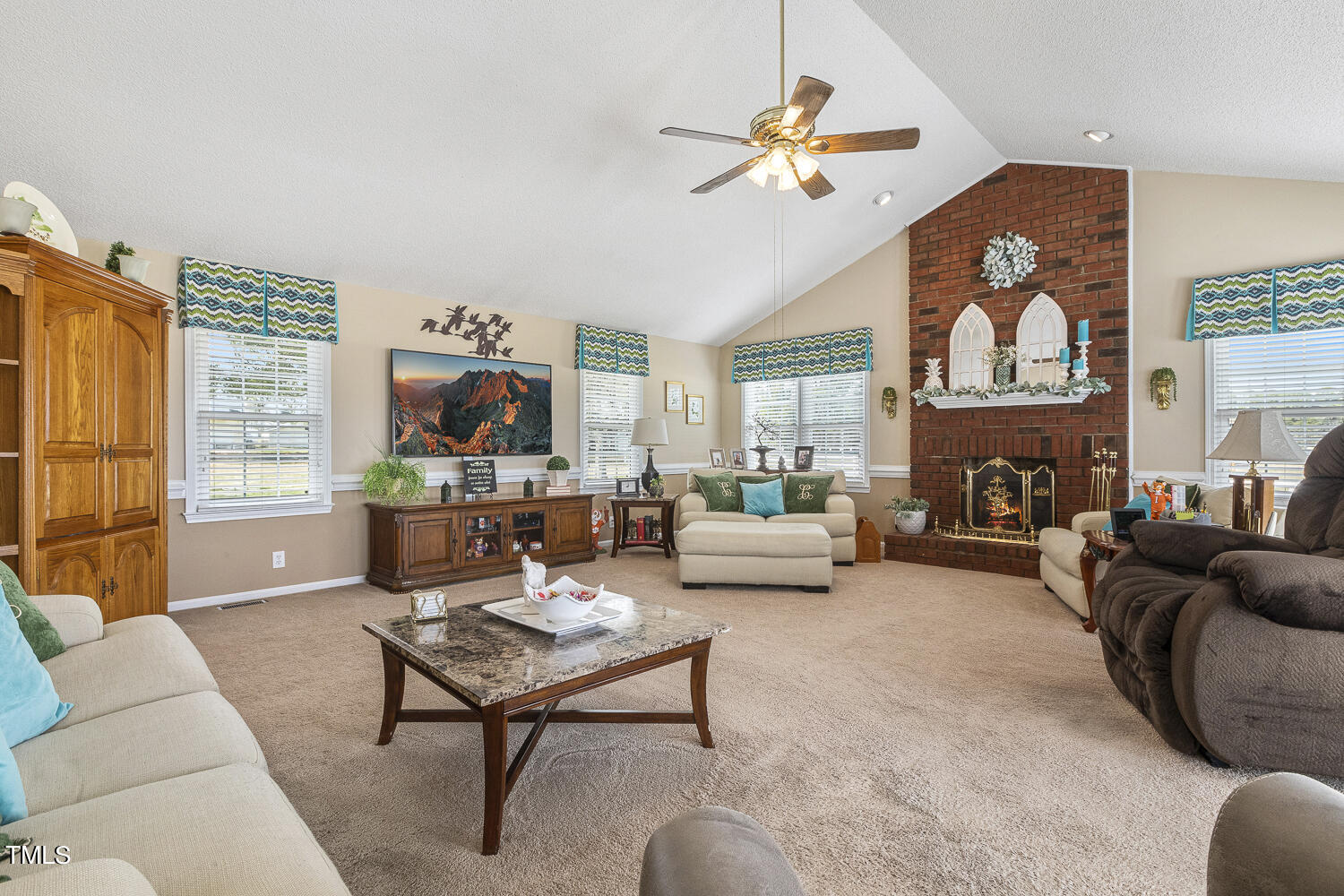 195 Williams Road Coats, NC 27521 - Photo 41 of 100 a living room with furniture a fireplace and a flat screen tv