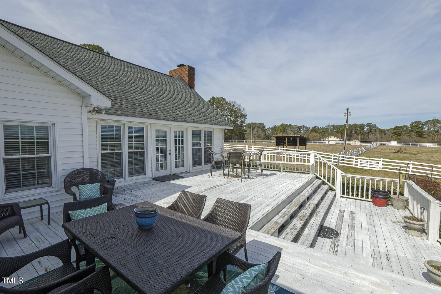 195 Williams Road Coats, NC 27521 - Photo 59 of 100 a view of a roof deck with table and chairs couches with wooden floor and fence