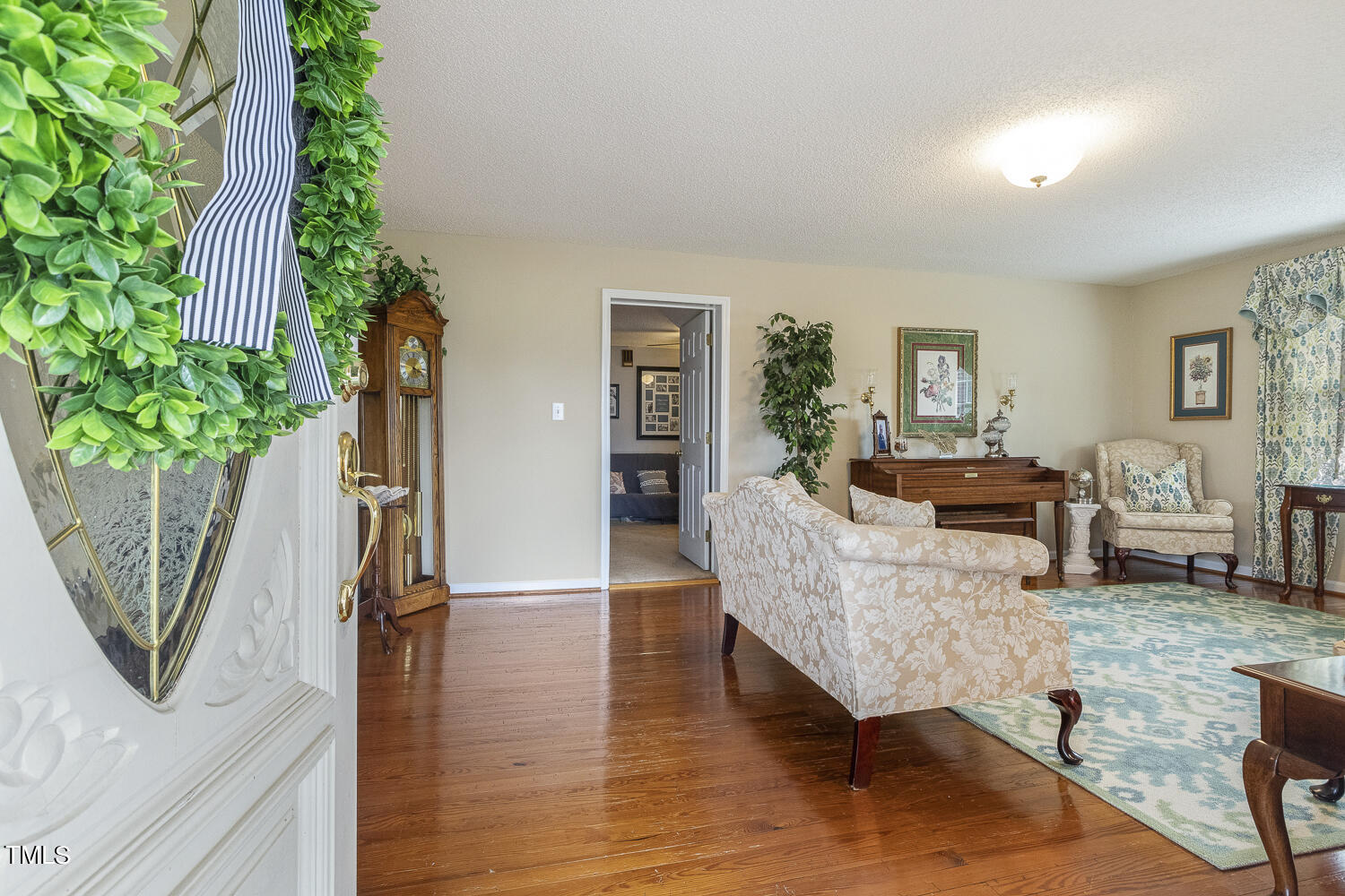 195 Williams Road Coats, NC 27521 - Photo 10 of 100 a living room with furniture a potted plant and a wooden floor