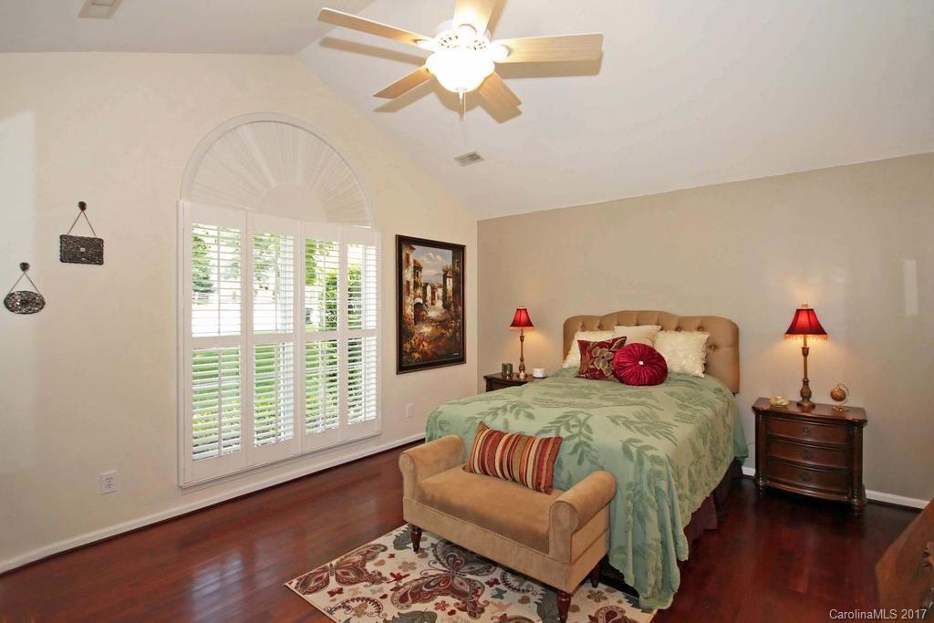 153 Kilborne Road Mooresville, NC 28117 - Photo 11 of 24 a bedroom with a bed and a chandelier