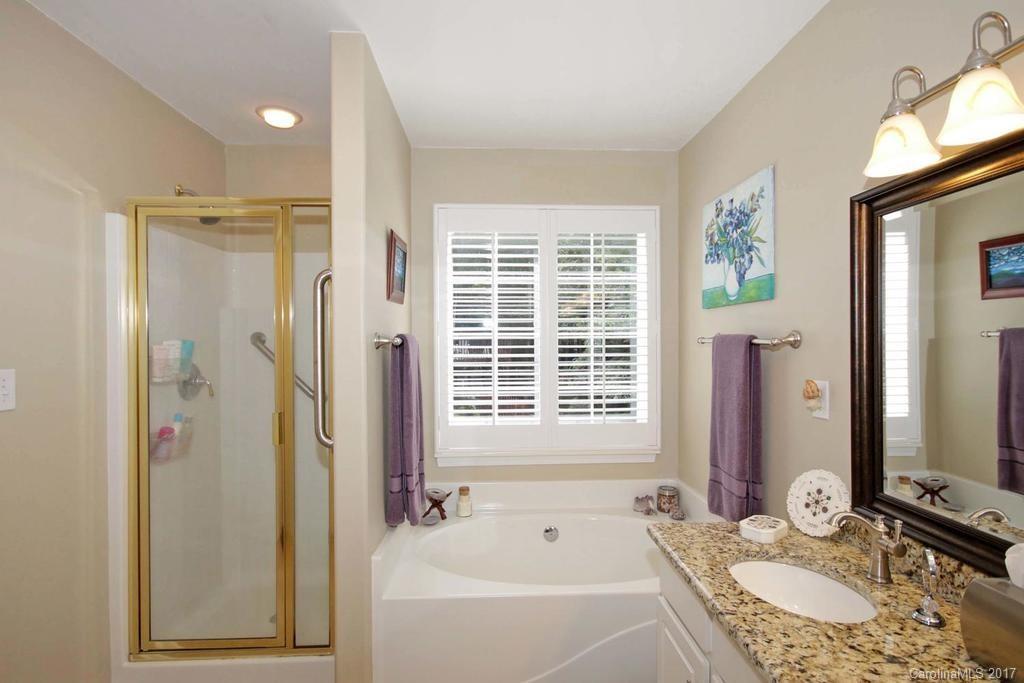 153 Kilborne Road Mooresville, NC 28117 - Photo 14 of 24 a bathroom with a granite countertop tub sink and mirror