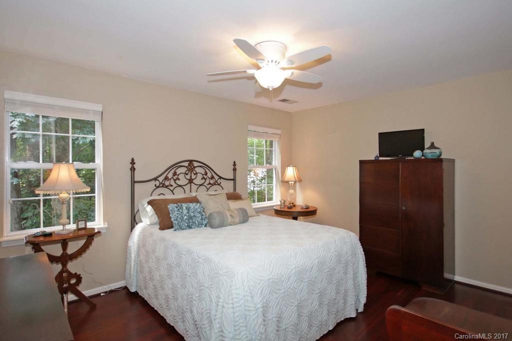 153 Kilborne Road Mooresville, NC 28117 - Photo 17 of 24 a bedroom with a bed and a chandelier