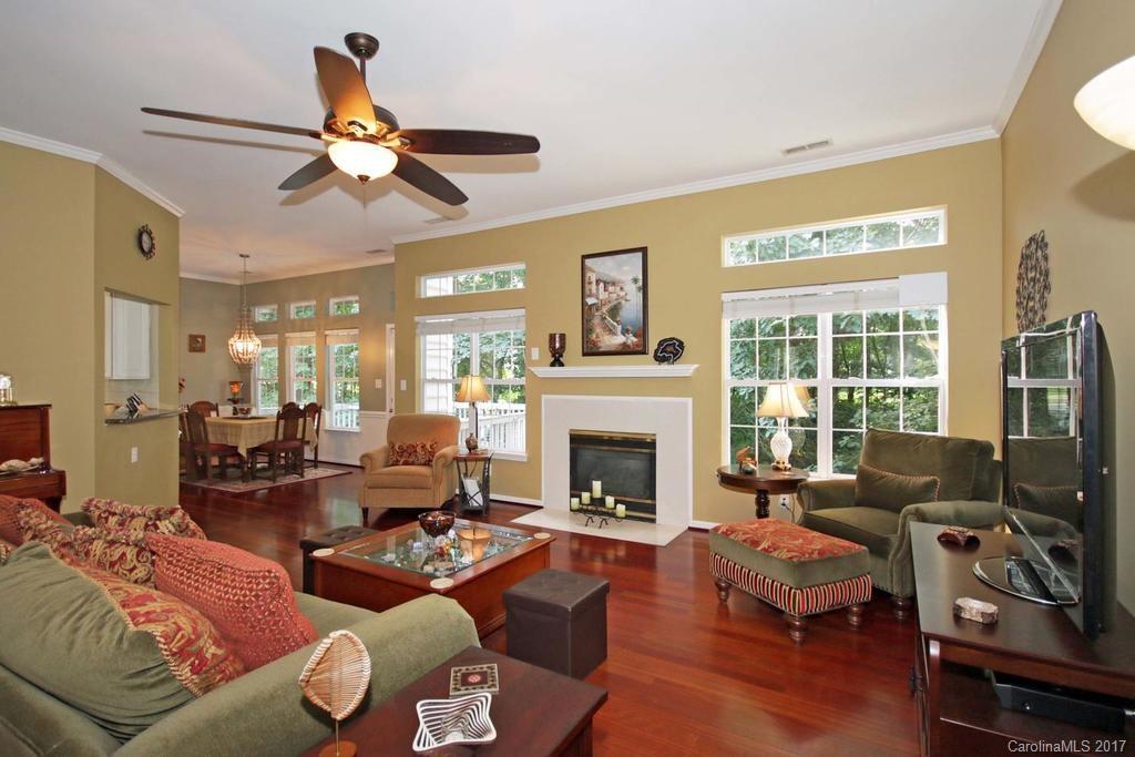 153 Kilborne Road Mooresville, NC 28117 - Photo 3 of 24 a living room with furniture a fireplace and a flat screen tv