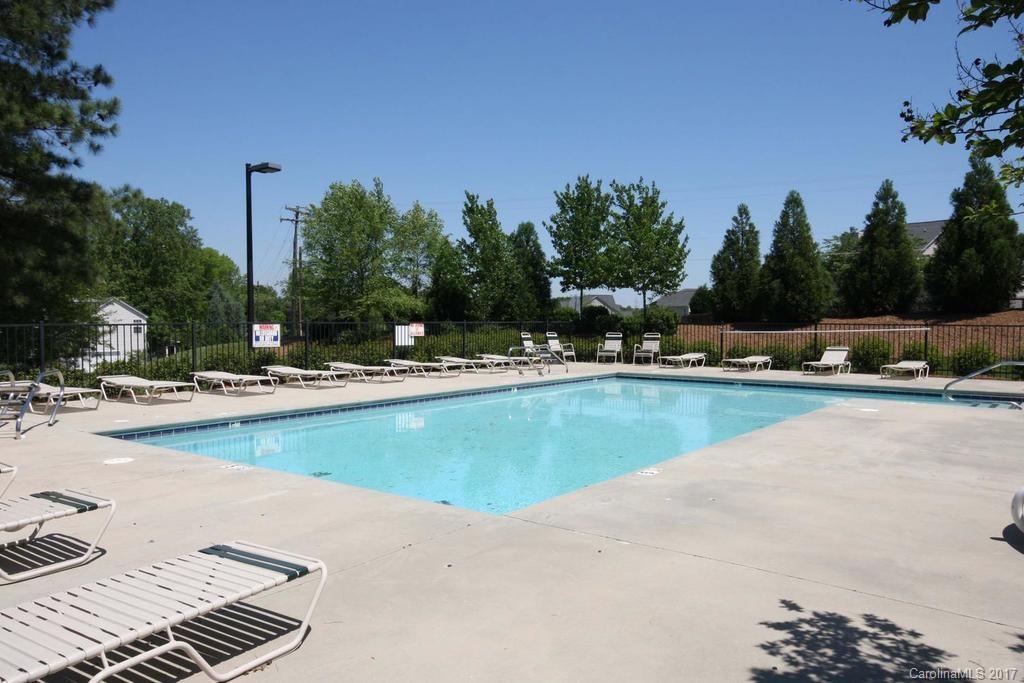 153 Kilborne Road Mooresville, NC 28117 - Photo 23 of 24 a view of swimming pool with outdoor seating and trees in the background
