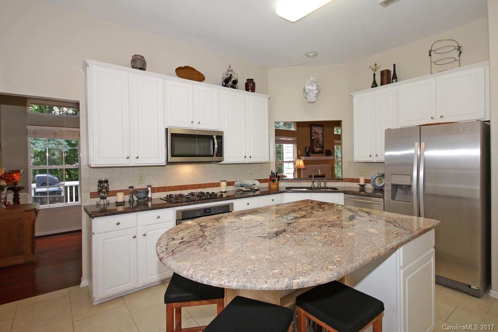 153 Kilborne Road Mooresville, NC 28117 - Photo 8 of 24 a kitchen with a stove a sink a microwave and refrigerator