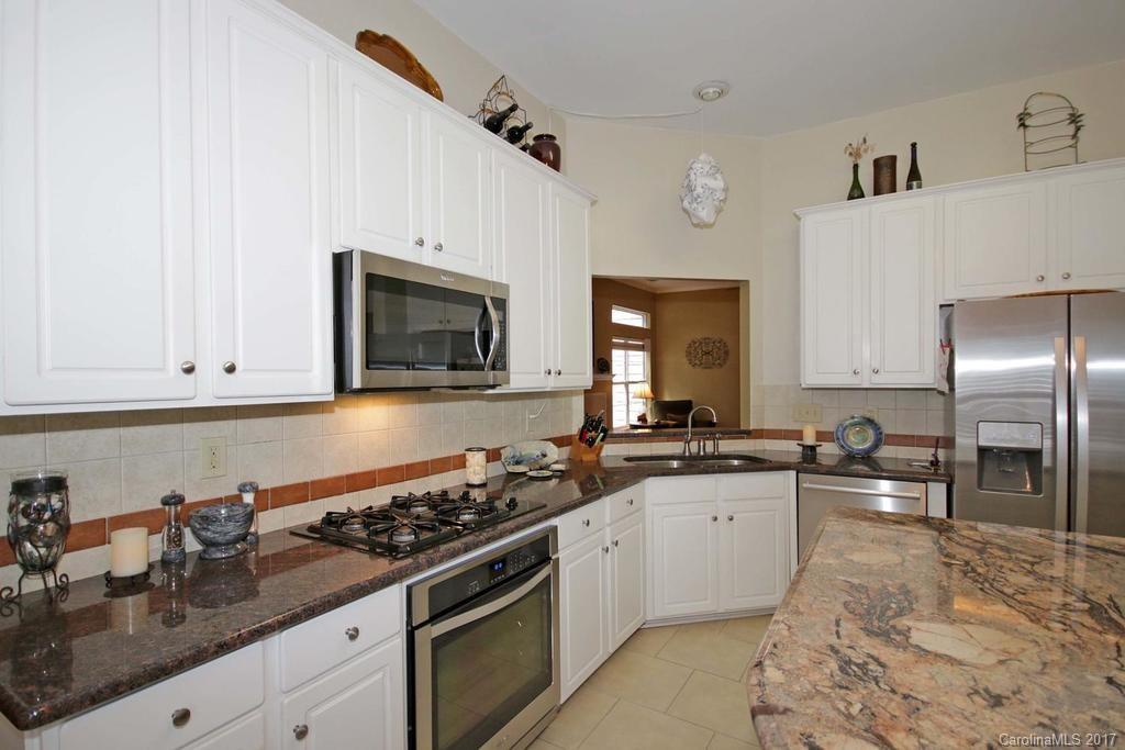 153 Kilborne Road Mooresville, NC 28117 - Photo 10 of 24 a kitchen with granite countertop a sink a stove and cabinets
