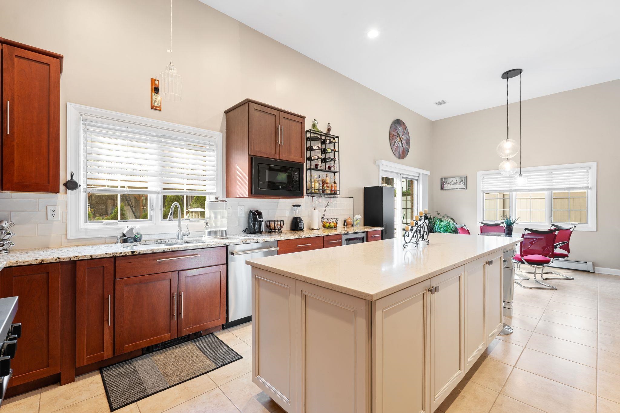 88 Myrtle Avenue, Unit B Edgewater, NJ 07020 - Photo 13 of 49 a large kitchen with stainless steel appliances a sink and dishwasher