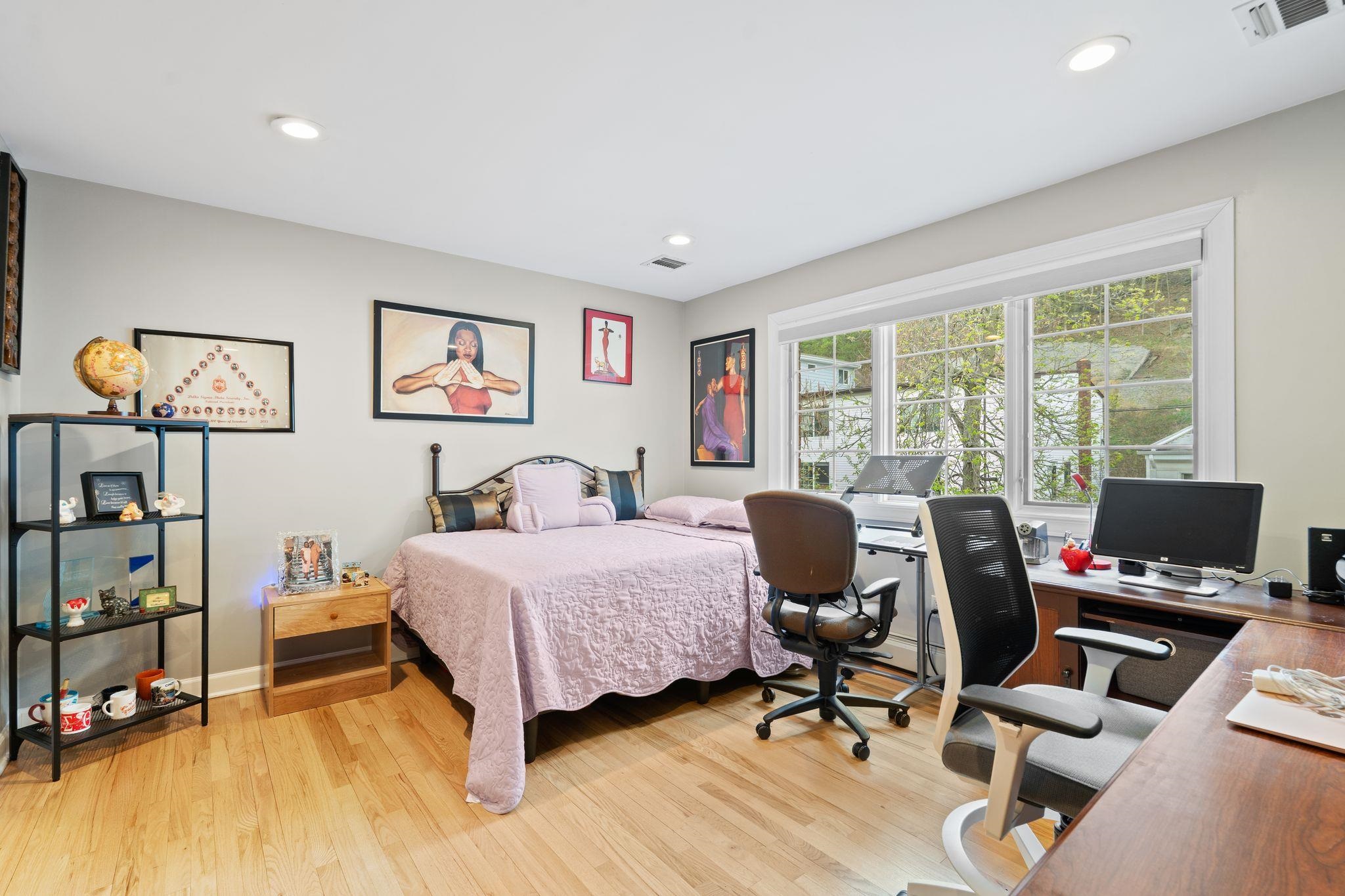 88 Myrtle Avenue, Unit B Edgewater, NJ 07020 - Photo 22 of 49 a bedroom with a bed and large windows