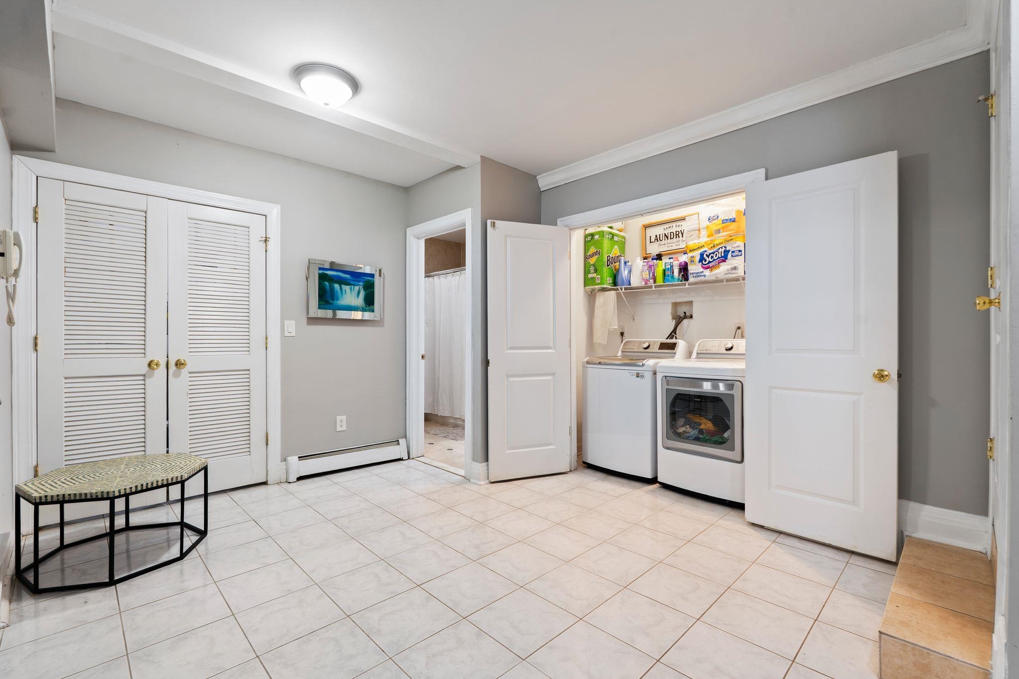 88 Myrtle Avenue, Unit B Edgewater, NJ 07020 - Photo 26 of 49 a utility room with cabinets dryer and washer