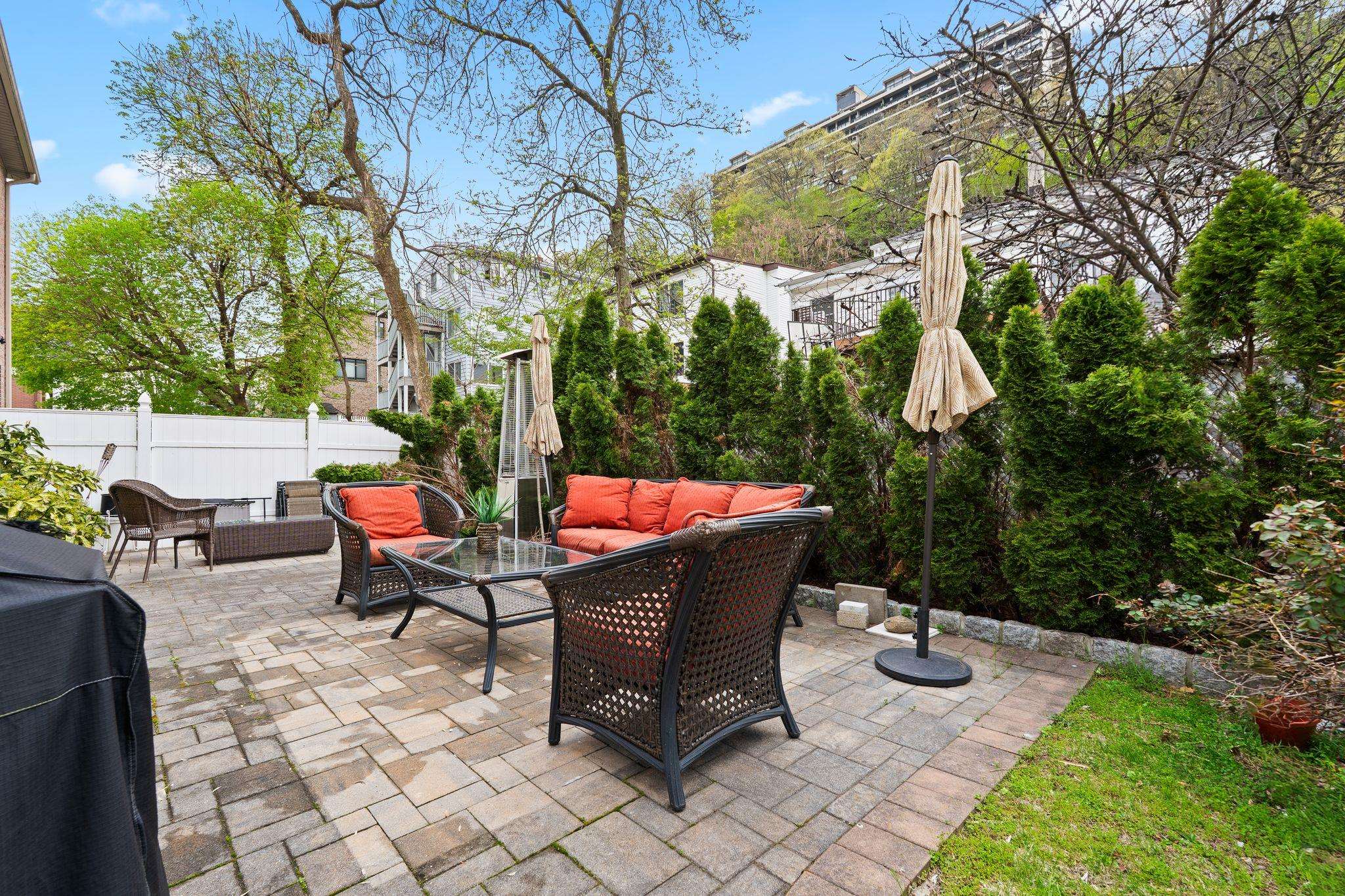88 Myrtle Avenue, Unit B Edgewater, NJ 07020 - Photo 28 of 49 a backyard of a house with table and chairs