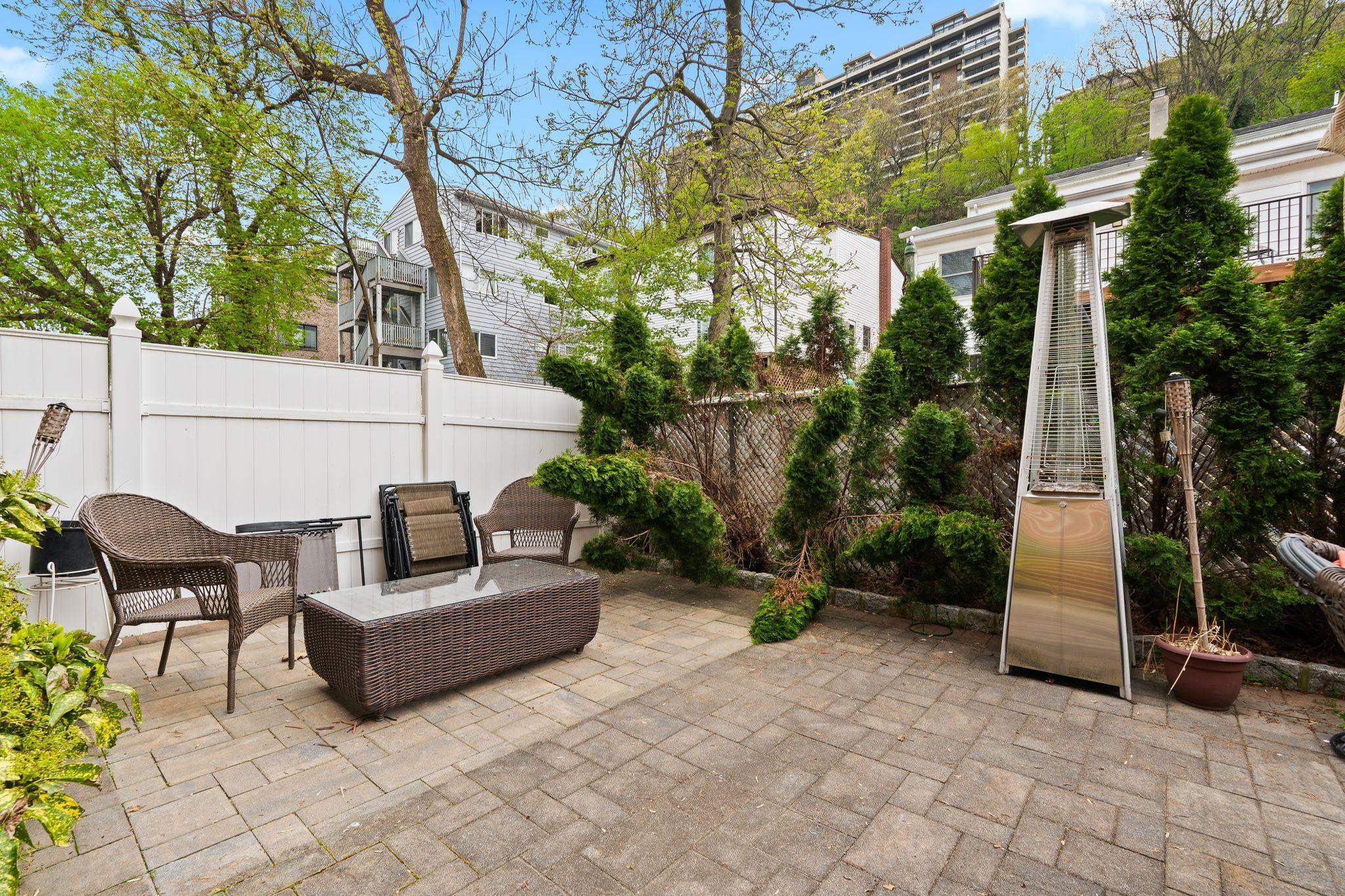 88 Myrtle Avenue, Unit B Edgewater, NJ 07020 - Photo 29 of 49 a backyard of a house with sofas fire pit and outdoor seating