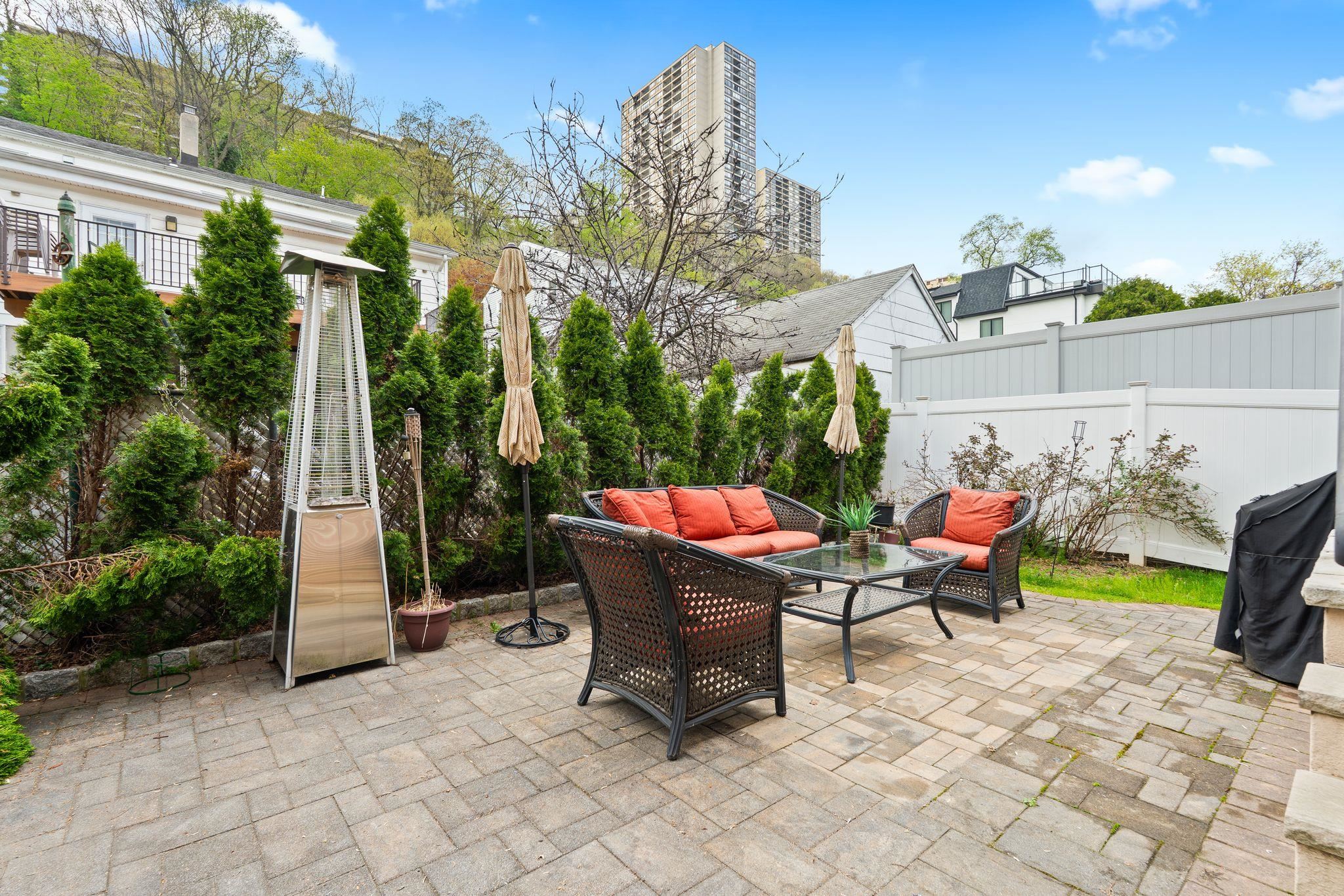 88 Myrtle Avenue, Unit B Edgewater, NJ 07020 - Photo 30 of 49 a backyard of a house with yard and outdoor seating