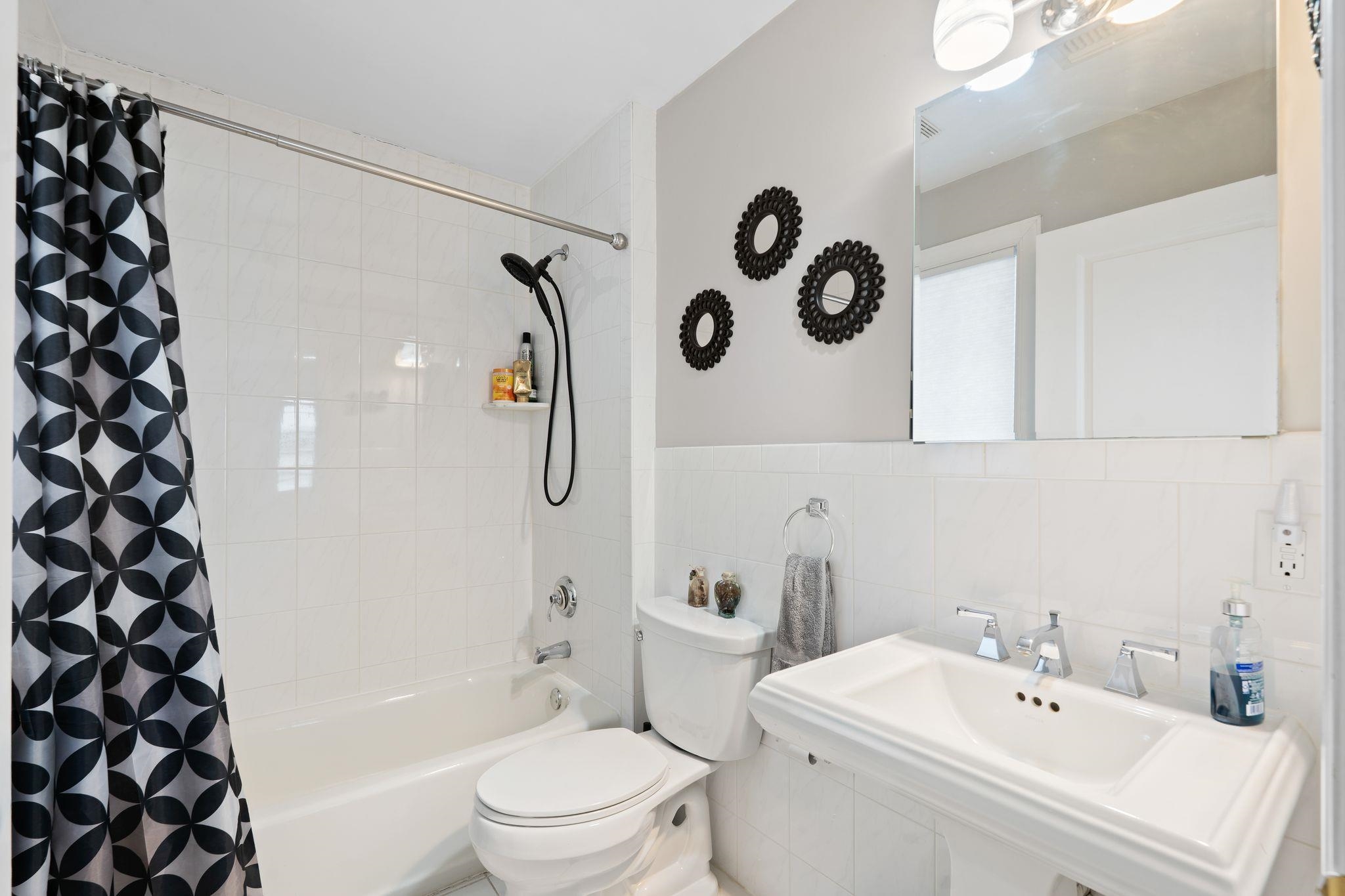 88 Myrtle Avenue, Unit B Edgewater, NJ 07020 - Photo 33 of 49 a white toilet sitting next to a bathroom sink