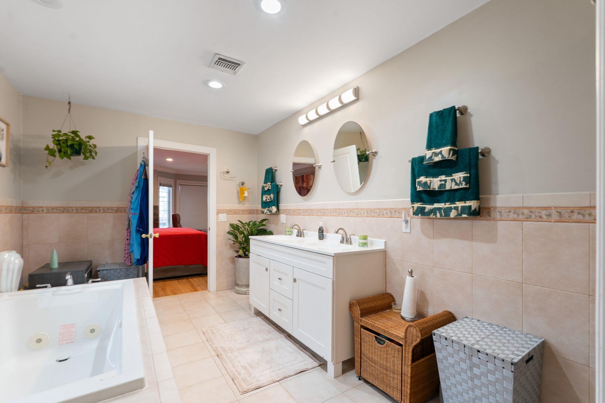 88 Myrtle Avenue, Unit B Edgewater, NJ 07020 - Photo 37 of 49 a spacious bathroom with a tub sink and mirror