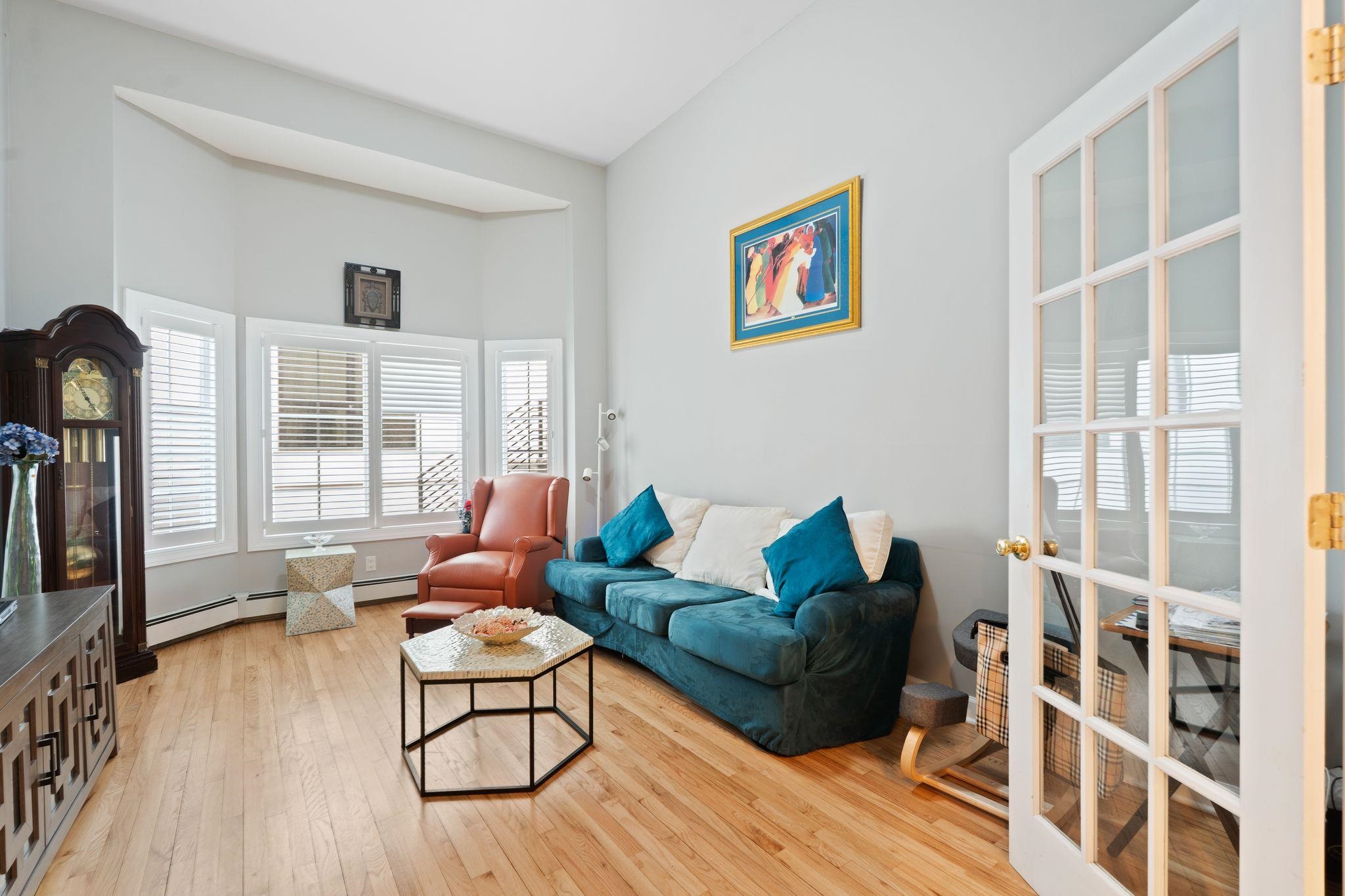88 Myrtle Avenue, Unit B Edgewater, NJ 07020 - Photo 8 of 49 a living room with furniture a large window and wooden floor