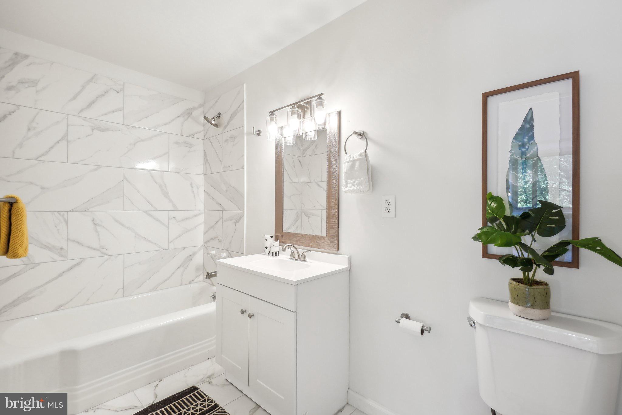 4101 Cathedral Avenue Northwest, Unit 306 Washington, DC 20016 - Photo 13 of 31 a bathroom with a sink a bathtub and a shower
