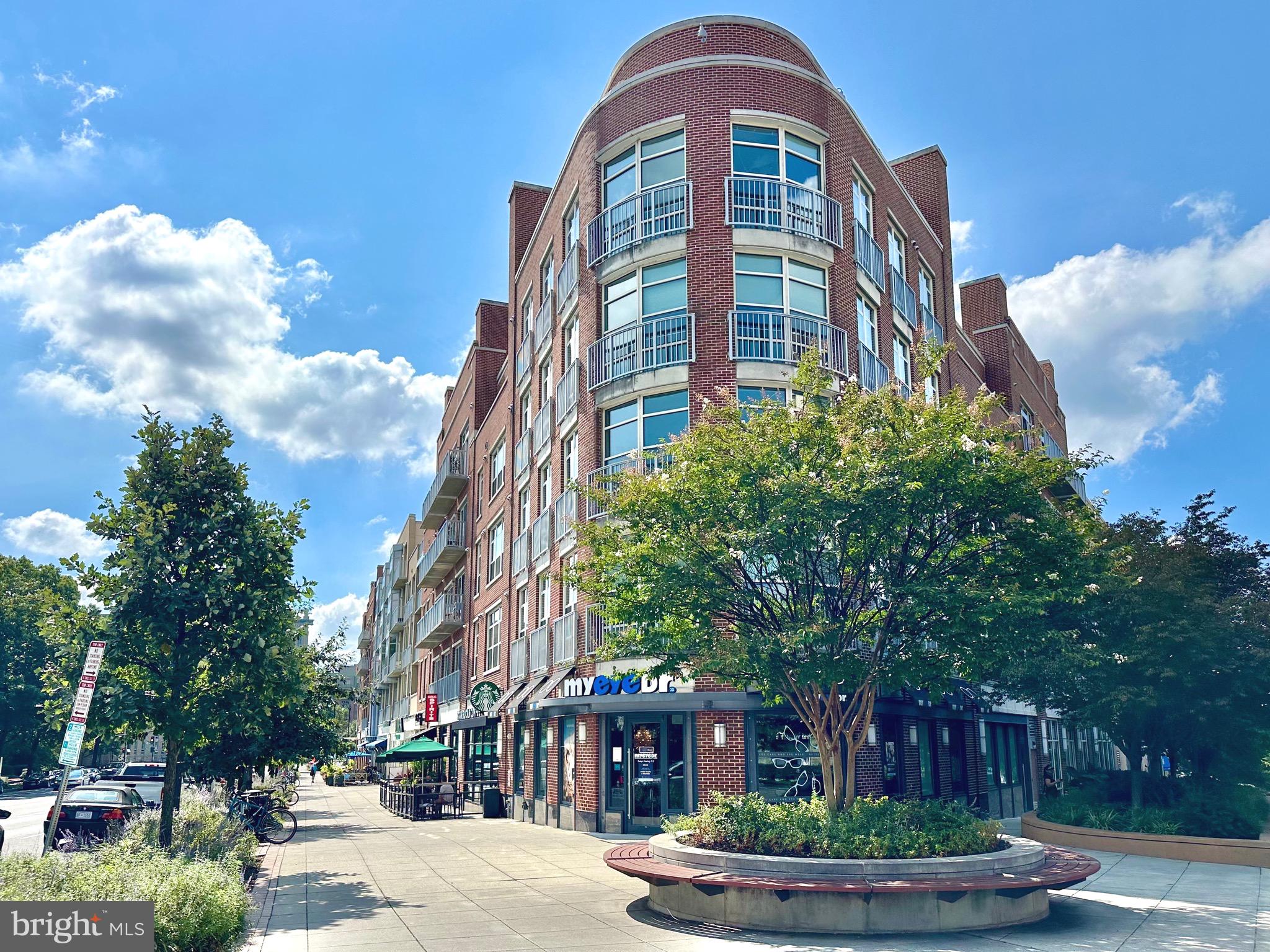 4101 Cathedral Avenue Northwest, Unit 306 Washington, DC 20016 - Photo 28 of 31 a front view of a residential apartment building with a yard