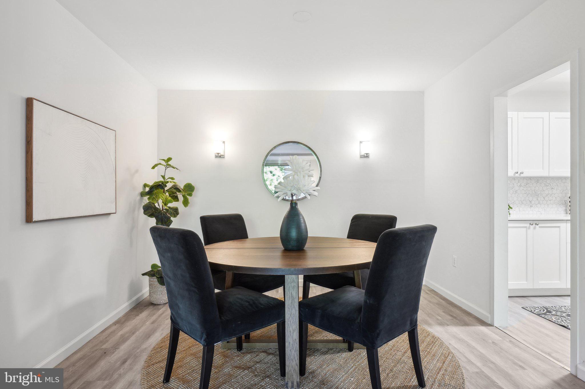 4101 Cathedral Avenue Northwest, Unit 306 Washington, DC 20016 - Photo 5 of 31 a view of a dining room with a table and chairs
