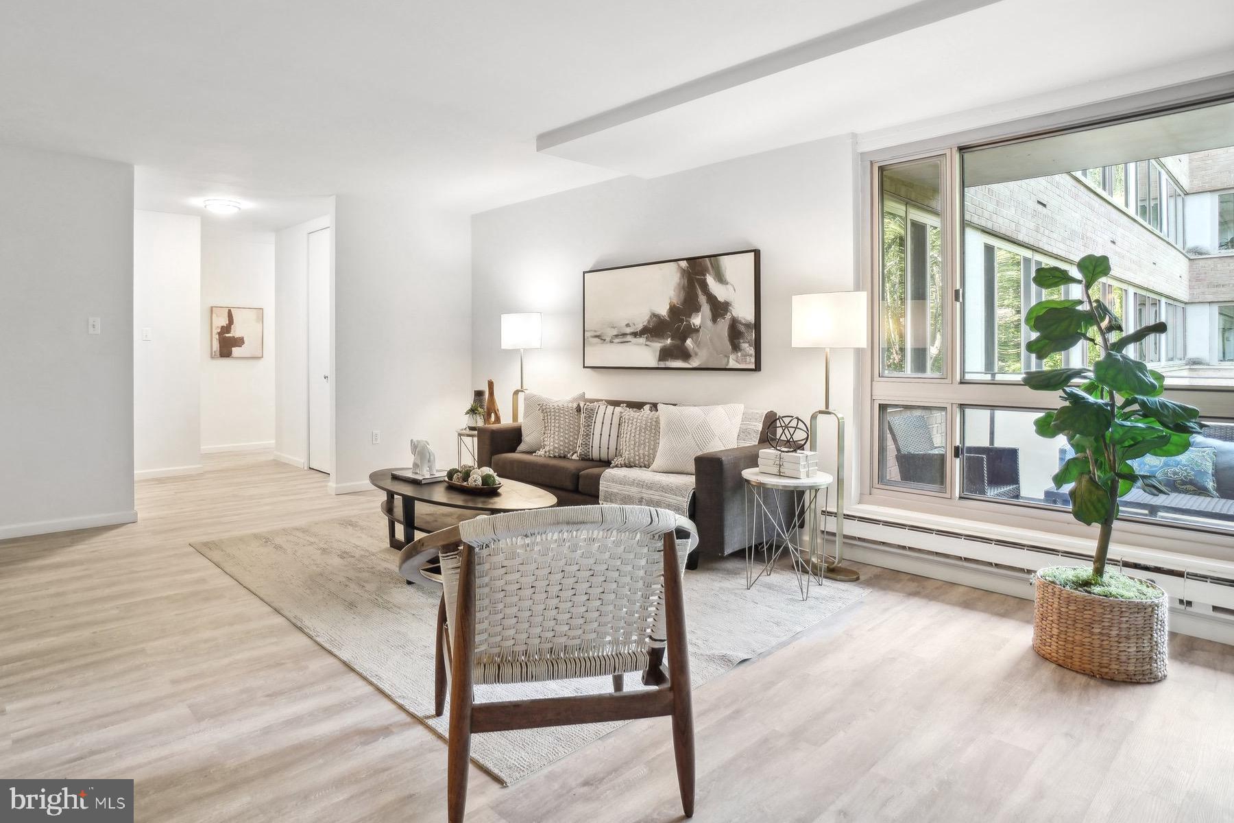 4101 Cathedral Avenue Northwest, Unit 306 Washington, DC 20016 - Photo 6 of 31 a living room with furniture and a potted plant
