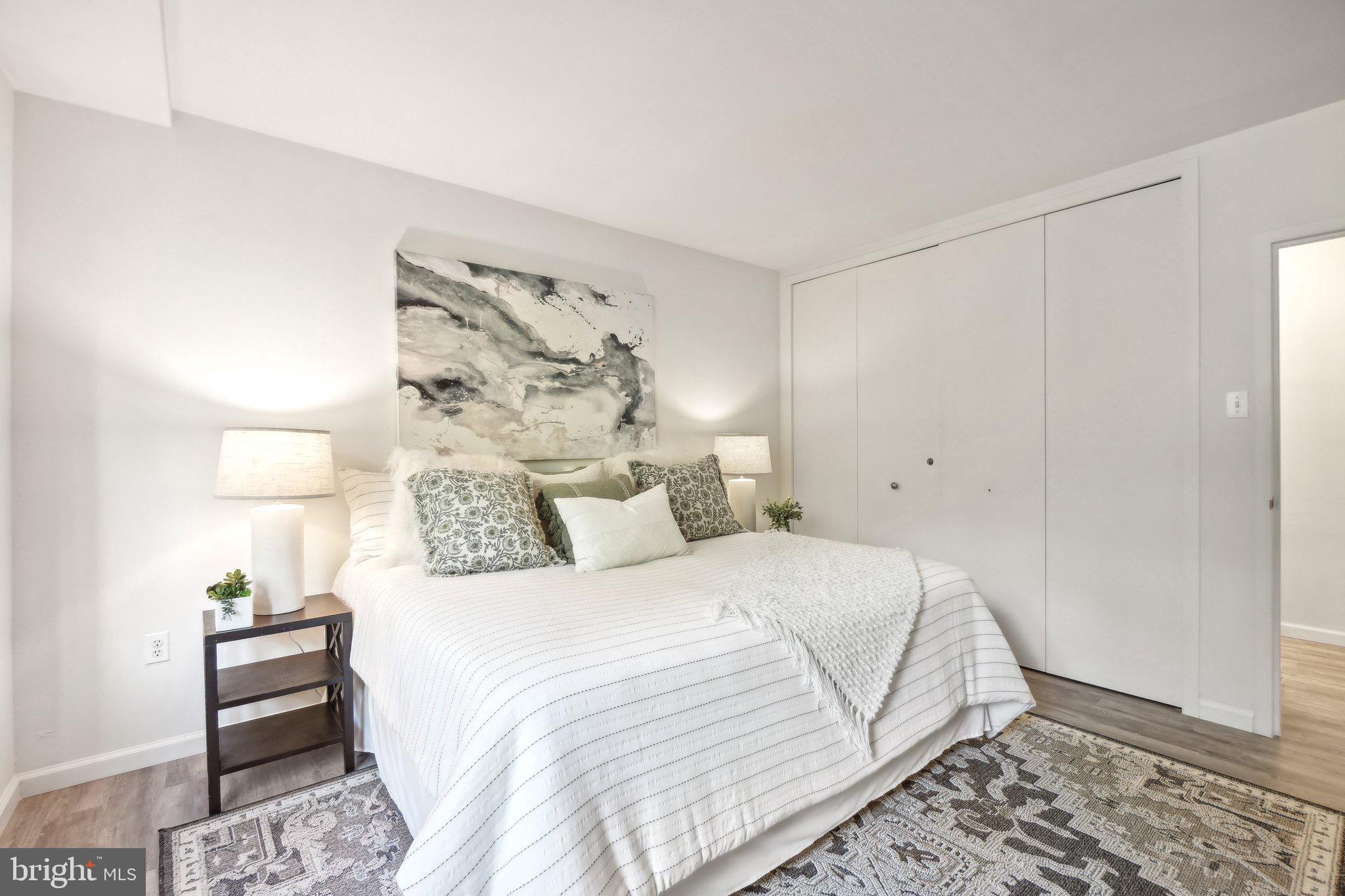 4101 Cathedral Avenue Northwest, Unit 306 Washington, DC 20016 - Photo 10 of 31 a bedroom with a bed and a window