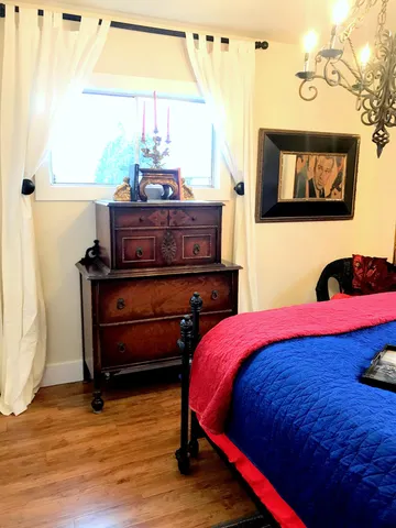 a bedroom with a bed and window