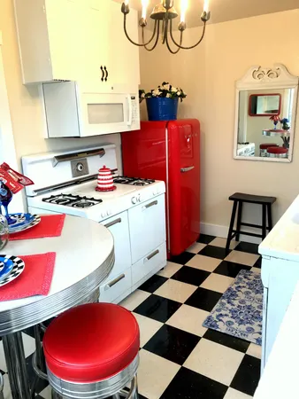 a storage & utility room with a rug a stove a rug and a window