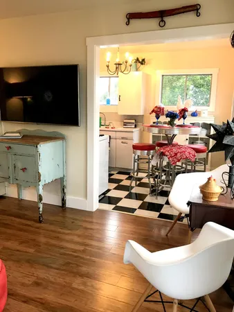 a room with wooden floor dining table and a large window