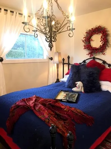 a bed sitting in a bedroom next to a window