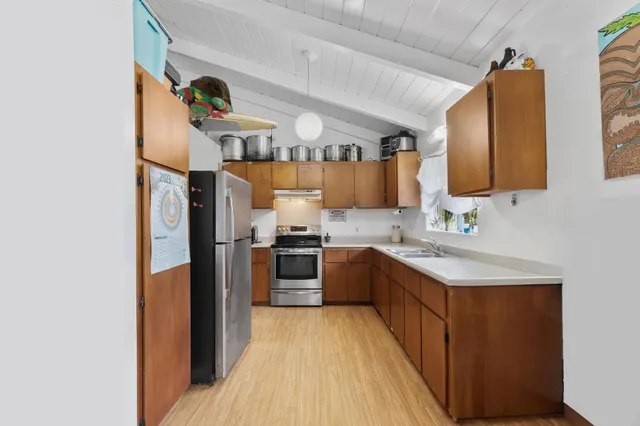 a kitchen with stainless steel appliances granite countertop a sink stove and refrigerator