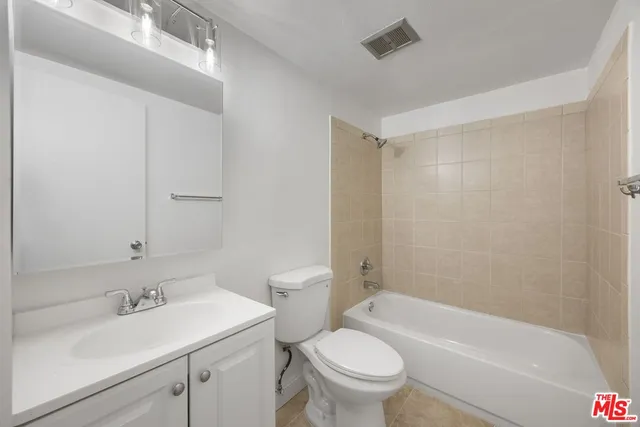 a bathroom with a sink a toilet and a bathtub