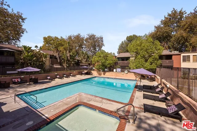 a view of a two chairs in the park