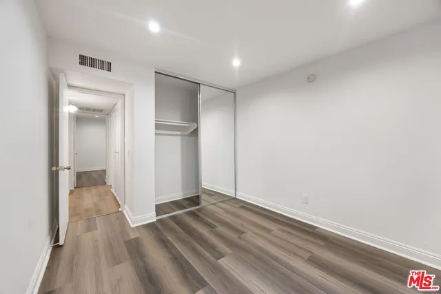 a view of hallway with wooden floor