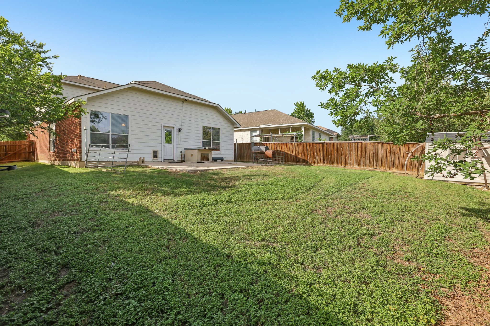 1721 Long Rifle Drive Austin, TX 78754 - Photo 31 of 38 A generously sized yard with a wood fence creates a private outdoor haven.