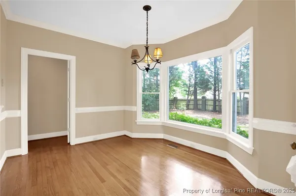 a view of a chandelier in big room and a chandelier