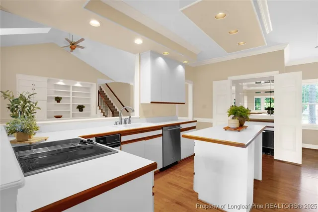 a kitchen with stainless steel appliances a stove a sink and a refrigerator